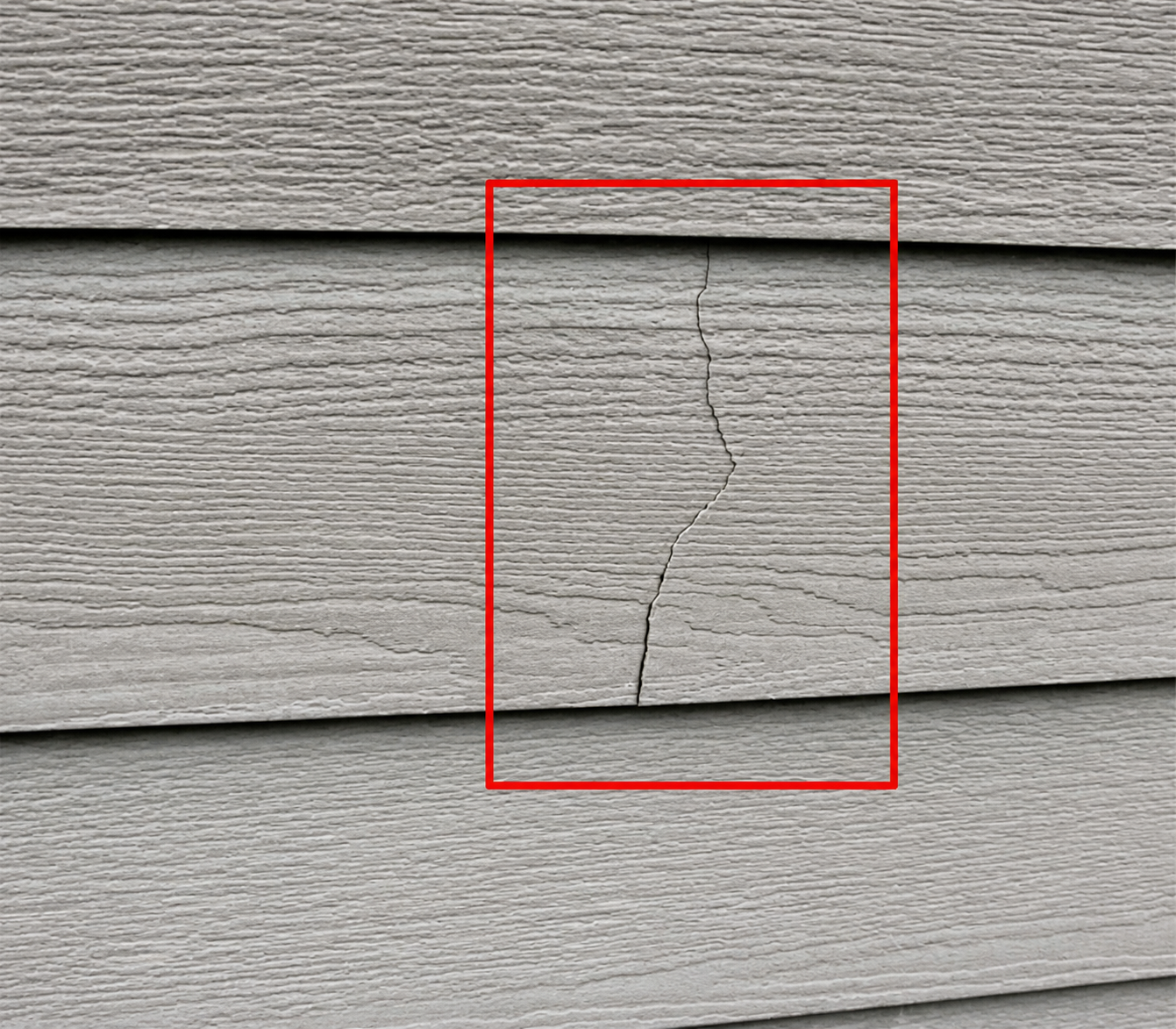 Crack running through a section of exterior siding